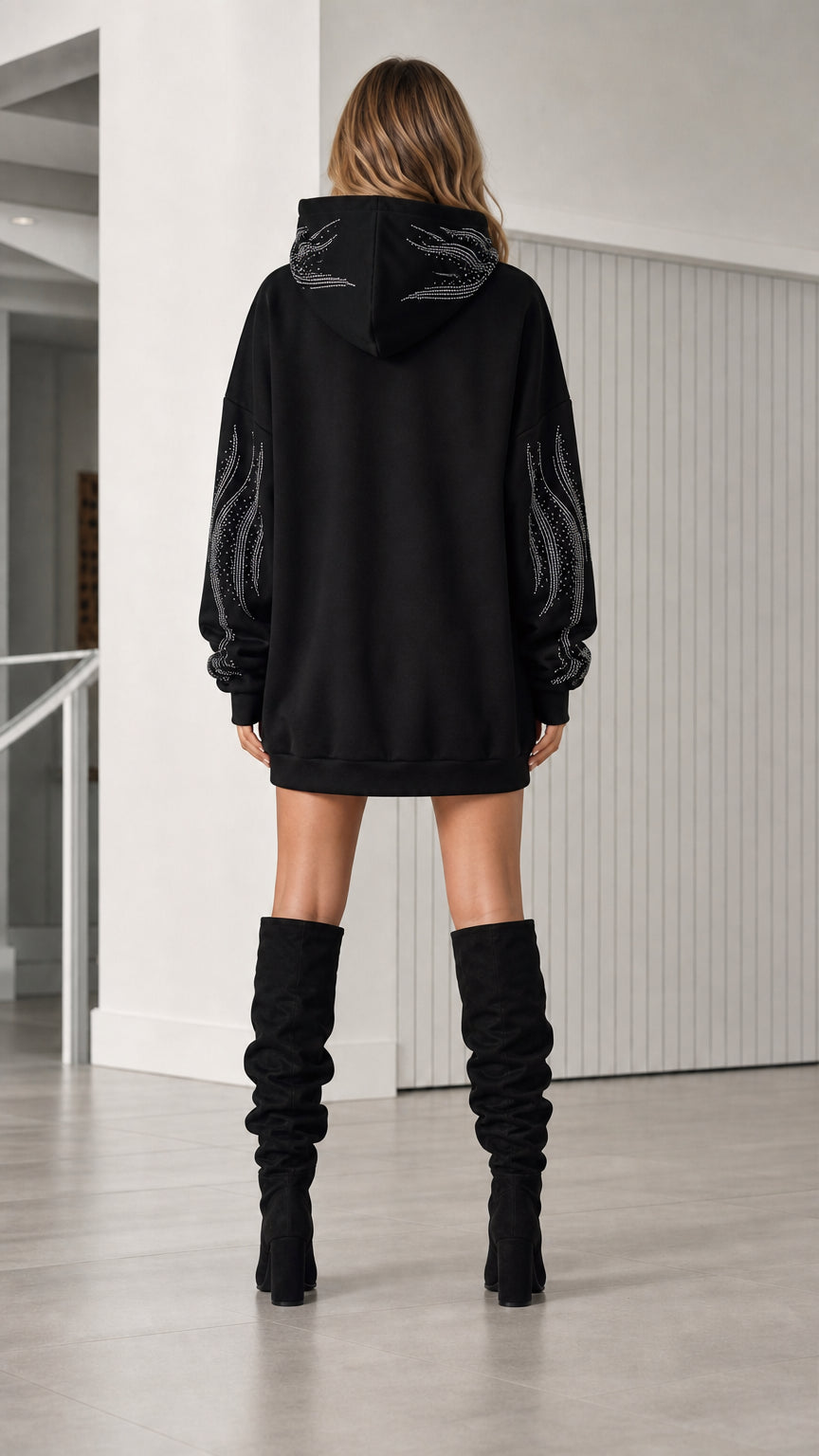 Back view of model in black rhinestone hoodie dress