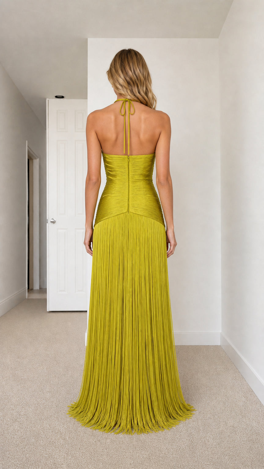 Back view of chartreuse open-back halter maxi dress with fringe skirt