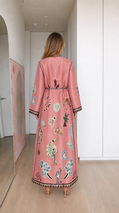 Model wearing pink boho printed long sleeve maxi dress, back view