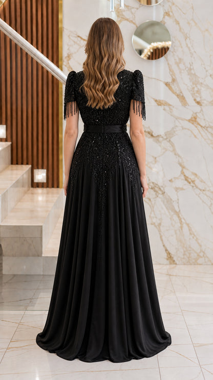 Back view of the black formal evening dress highlighting the fitted bodice and floor-length skirt