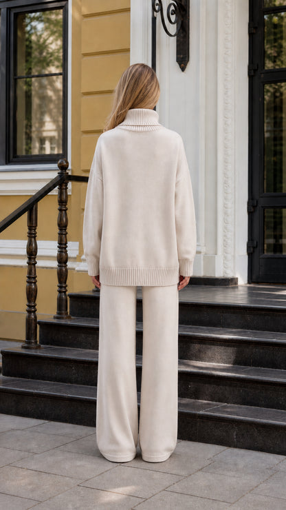 Back view of model in beige sweater and wide-leg pants