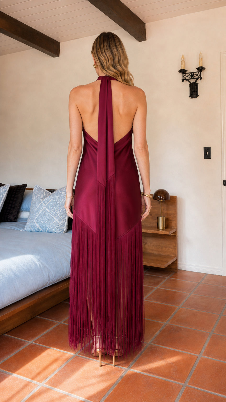 Back view of burgundy open-back satin halter gown with tie scarf