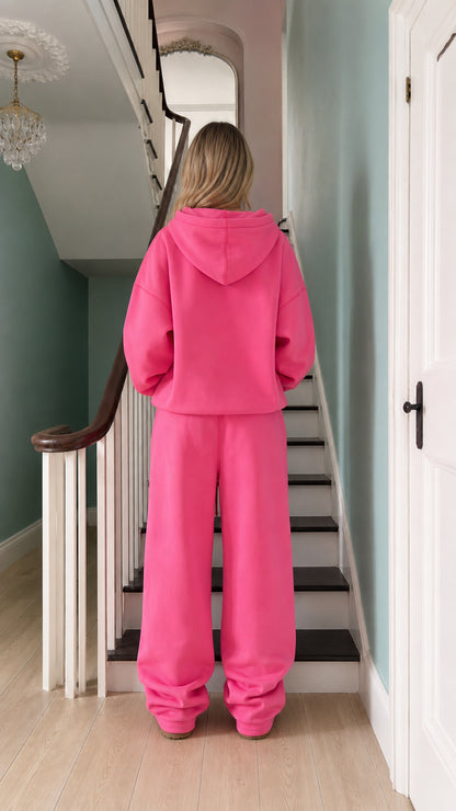 Back view of model wearing pink oversized hoodie and slouchy sweatpants