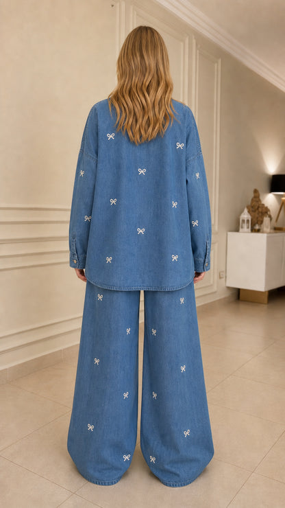 Woman wearing blue bow embroidered denim set back view