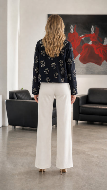 Woman wearing Navy embellished floral zip-up jacket, back view