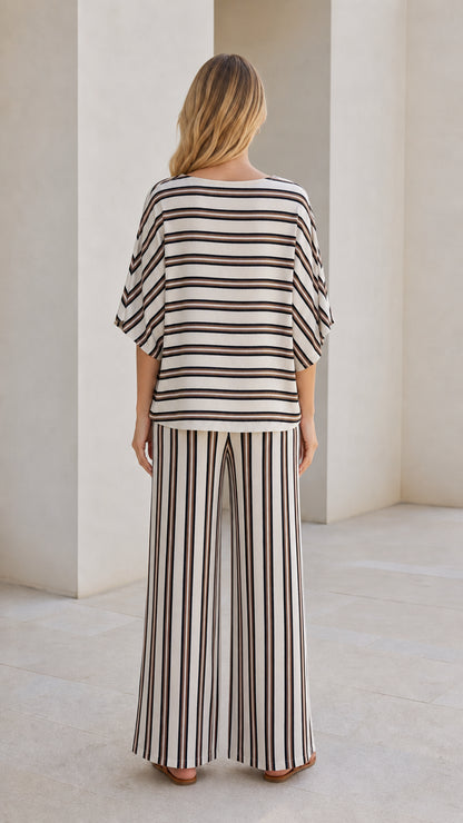 Model wearing beige striped set from back view