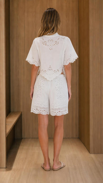 Back view of model wearing white eyelet embroidered set