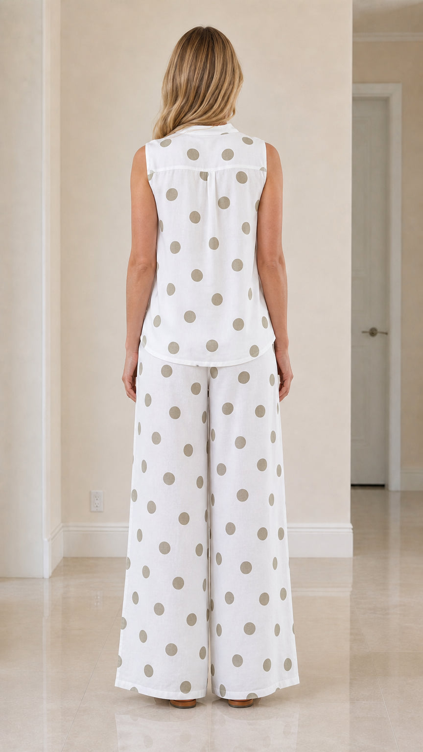 Woman wearing white polka dot two-piece set, back view