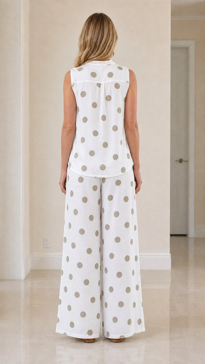 Woman wearing white polka dot two-piece set, back view