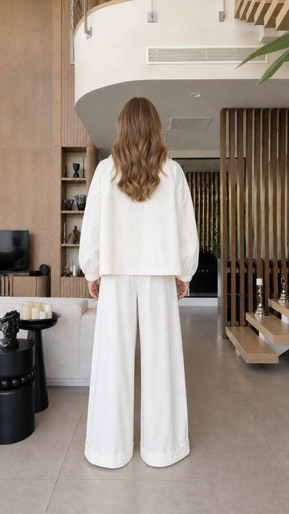 Back view of the white cropped blazer and matching wide-leg trousers