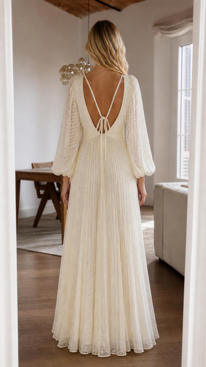Back view of cream pleated maxi dress showing strappy details