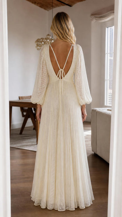 Back view of cream pleated maxi dress showing strappy details