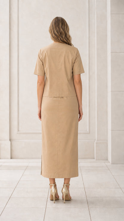 Back full view of woman wearing khaki short sleeve blouse and matching maxi skirt