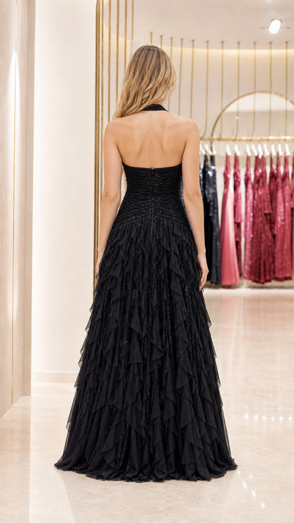 Back view of model showcasing the open back of the black dress