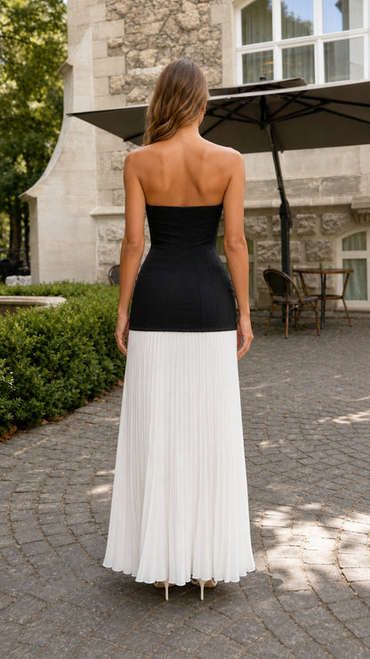 Back view of black and white colorblock strapless pleated maxi dress