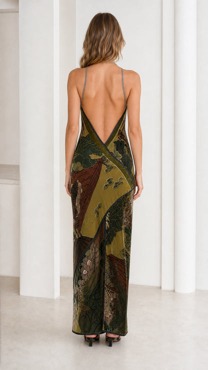 Model wearing olive green velvet halter maxi dress, back view with open back