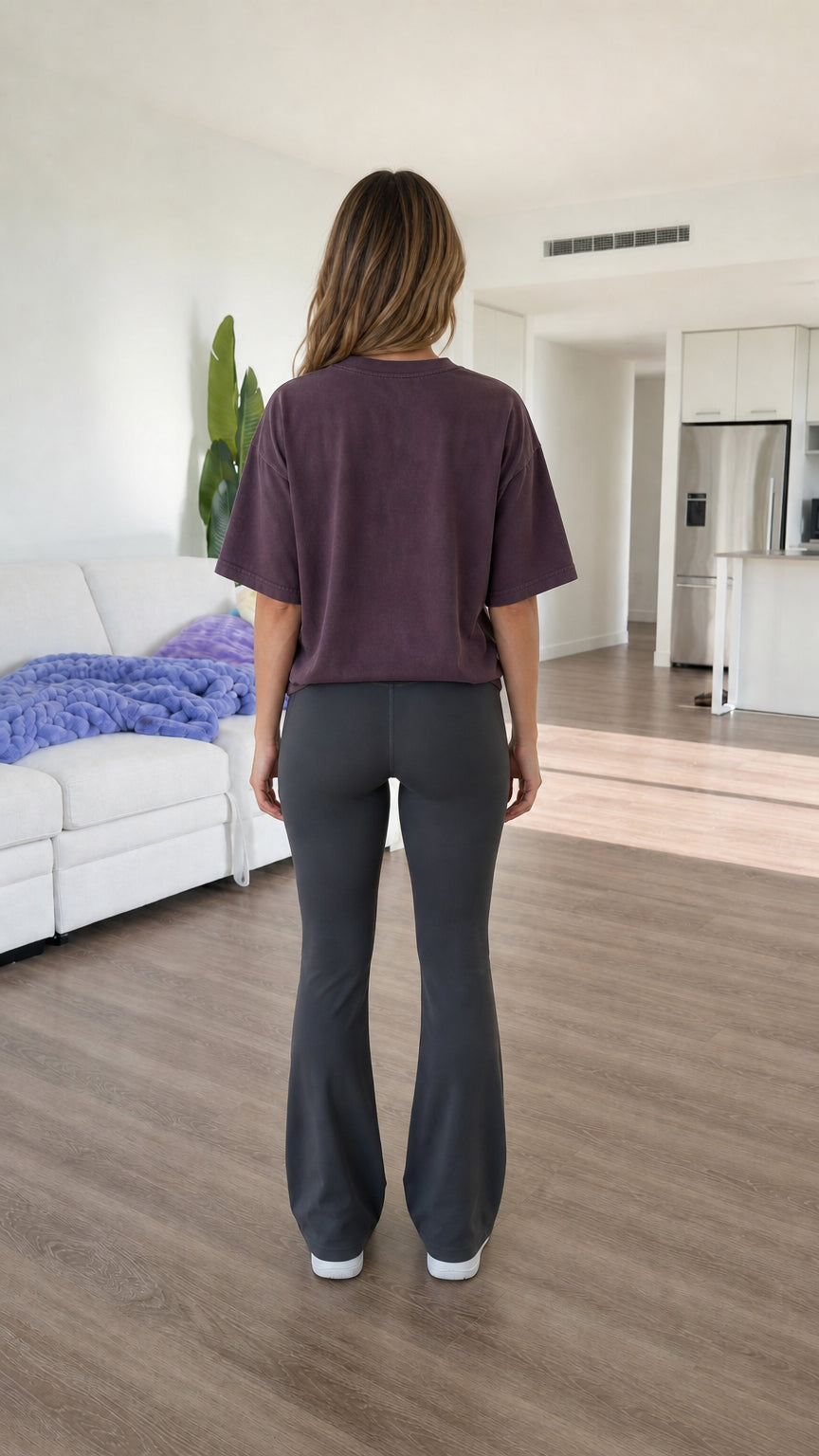Back view of model wearing Washed Plum oversized drop-shoulder graphic t-shirt