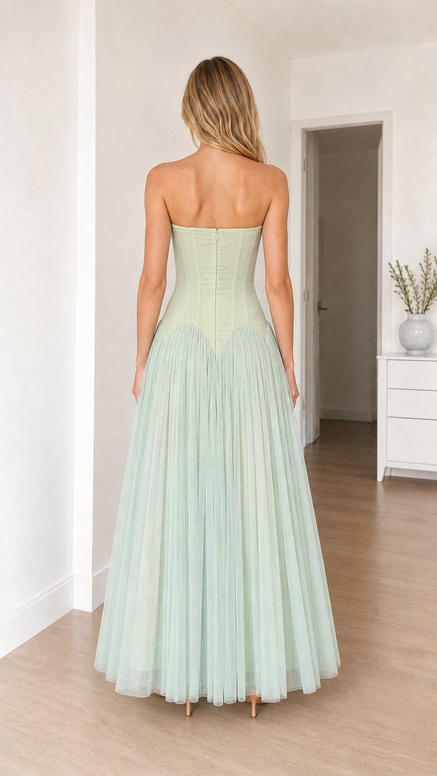 Model in sage green dress, back view