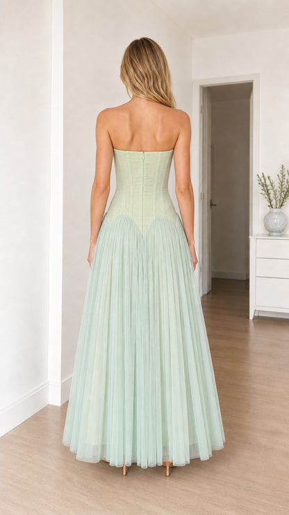 Model in sage green dress, back view
