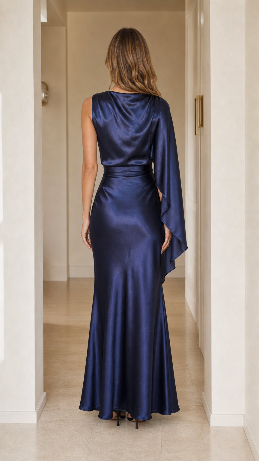 Back view of navy blue one-shoulder cape satin maxi evening dress