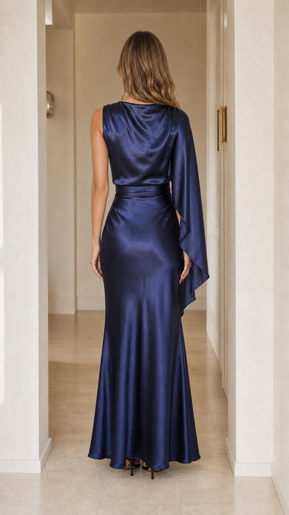 Back view of navy blue one-shoulder cape satin maxi evening dress