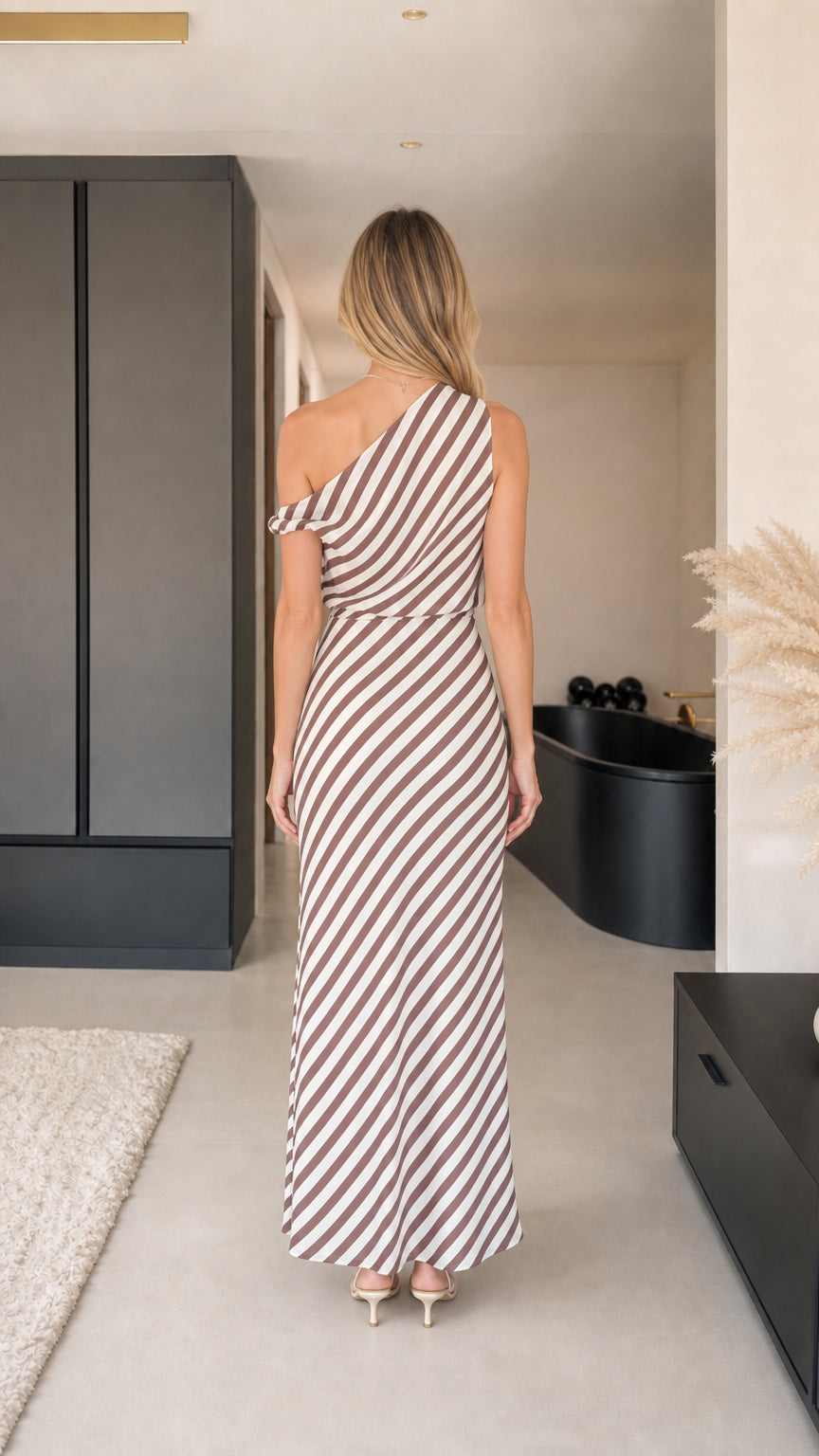 Back view of model in brown striped one-shoulder maxi dress