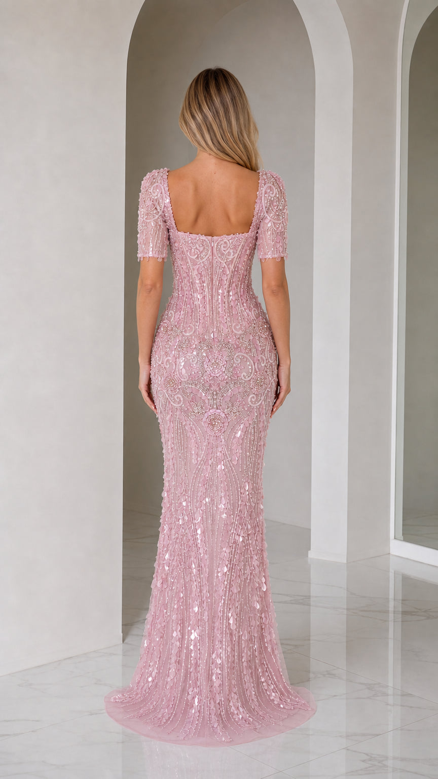 Back view of blush pink beaded evening gown showing low square back and fitted silhouette