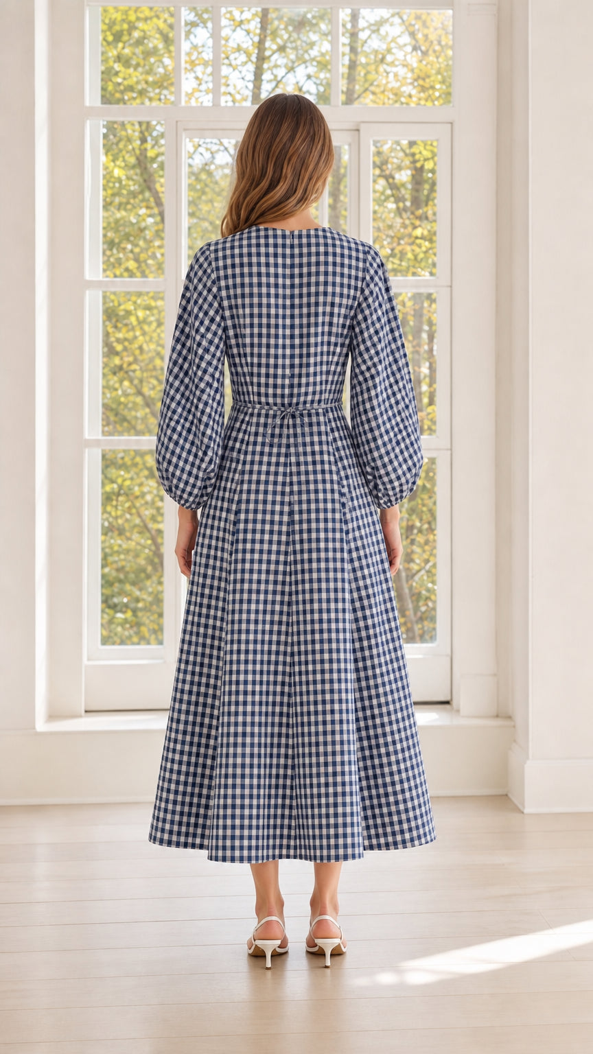 Back view of woman wearing blue gingham midi dress
