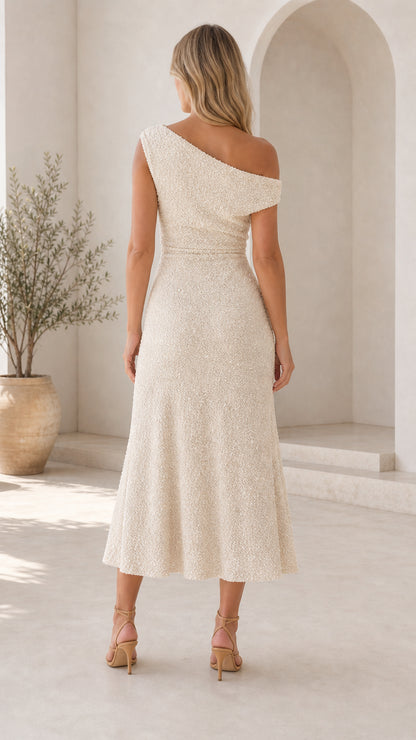 Back view of woman wearing cream one-shoulder dress