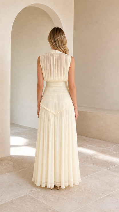 Back view of model in cream high-neck chiffon formal maxi dress