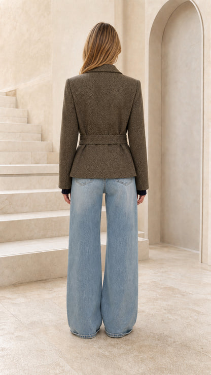 Back view of woman wearing olive tailored herringbone belted jacket
