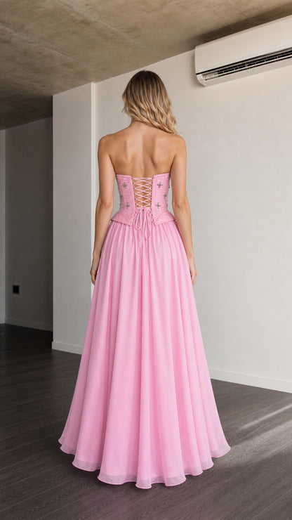 Back view showing lace-up corset detail on pink maxi dress