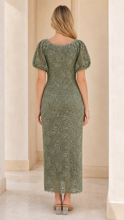 Back view of woman wearing sage green midi dress with lace detailing