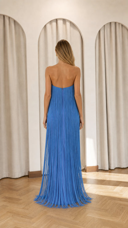 Back view of model in blue strapless fringe maxi dress