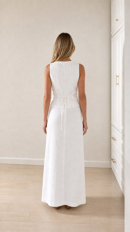 Back view of woman wearing white vest and maxi skirt set with back tie