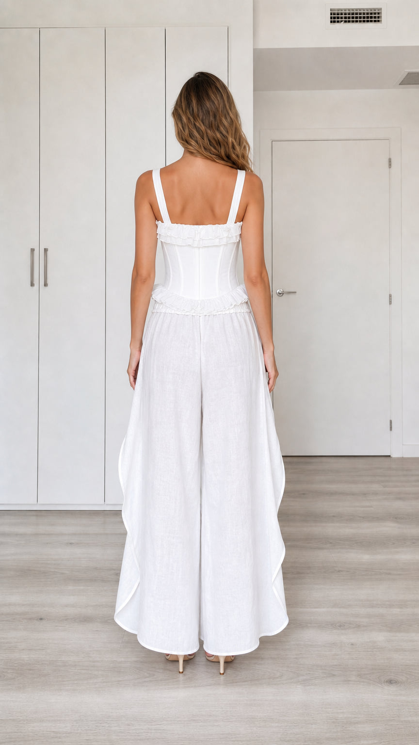 Model wearing white two-piece set, back view