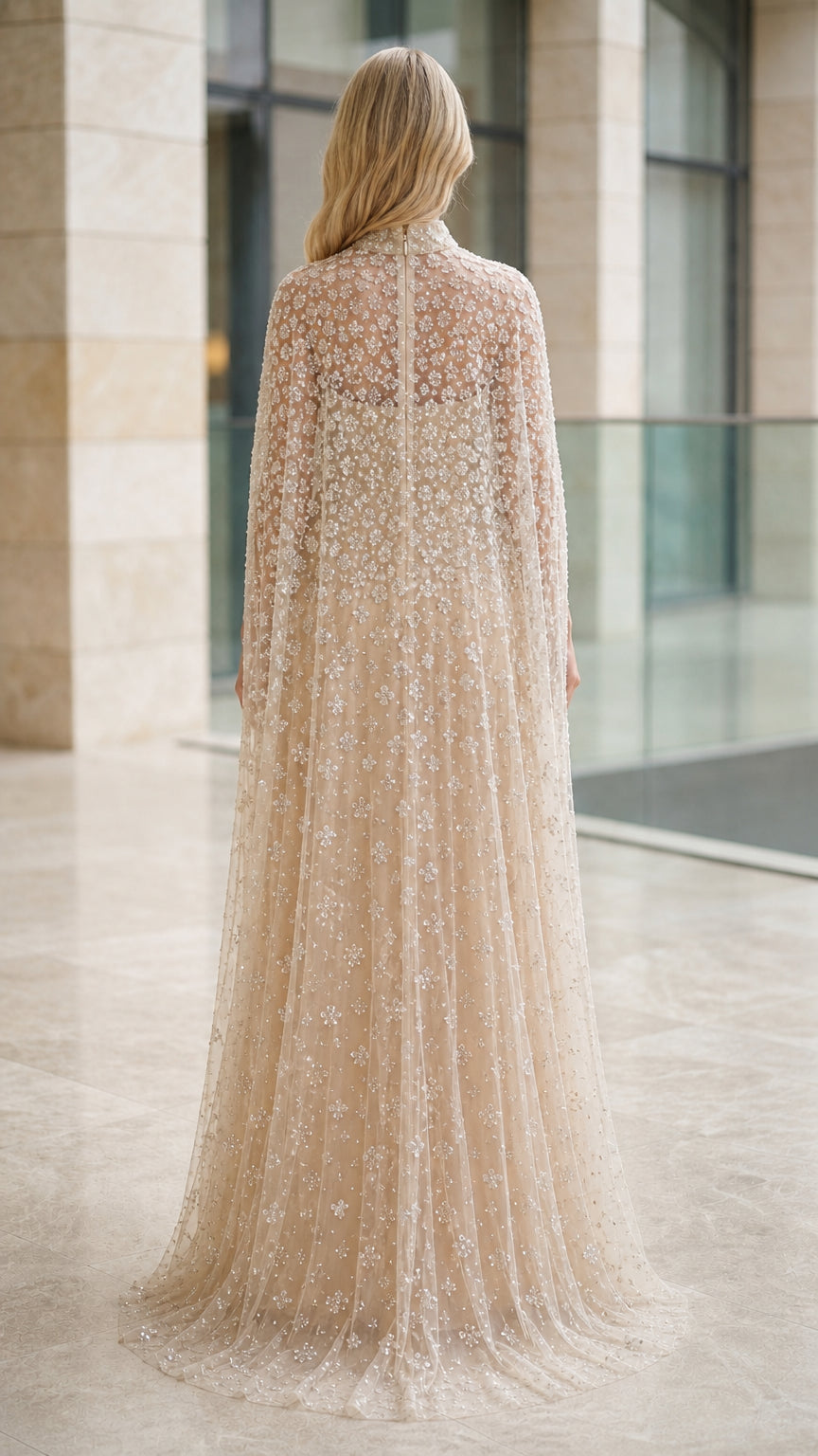 Back view of model in floor-length champagne sequin cape gown