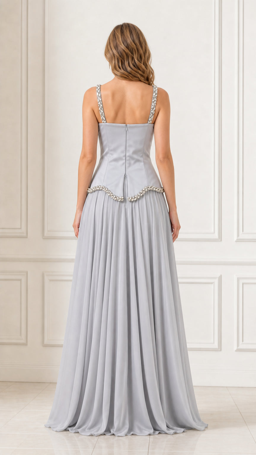 Back view of a woman wearing a silver chiffon maxi dress with back zipper detail