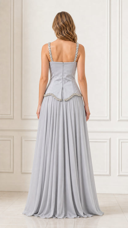 Back view of a woman wearing a silver chiffon maxi dress with back zipper detail