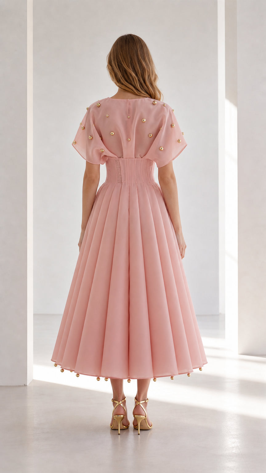 Back view of blush pink flutter sleeve pleated midi dress