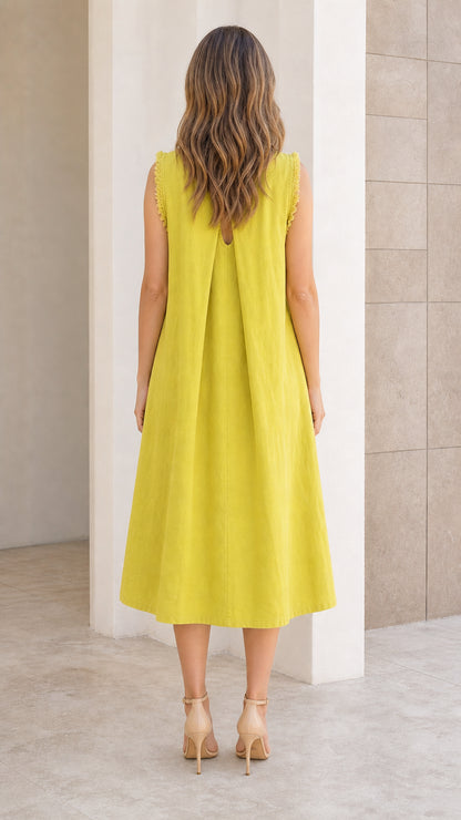 Back view of woman showing pleated back detail on chartreuse midi dress