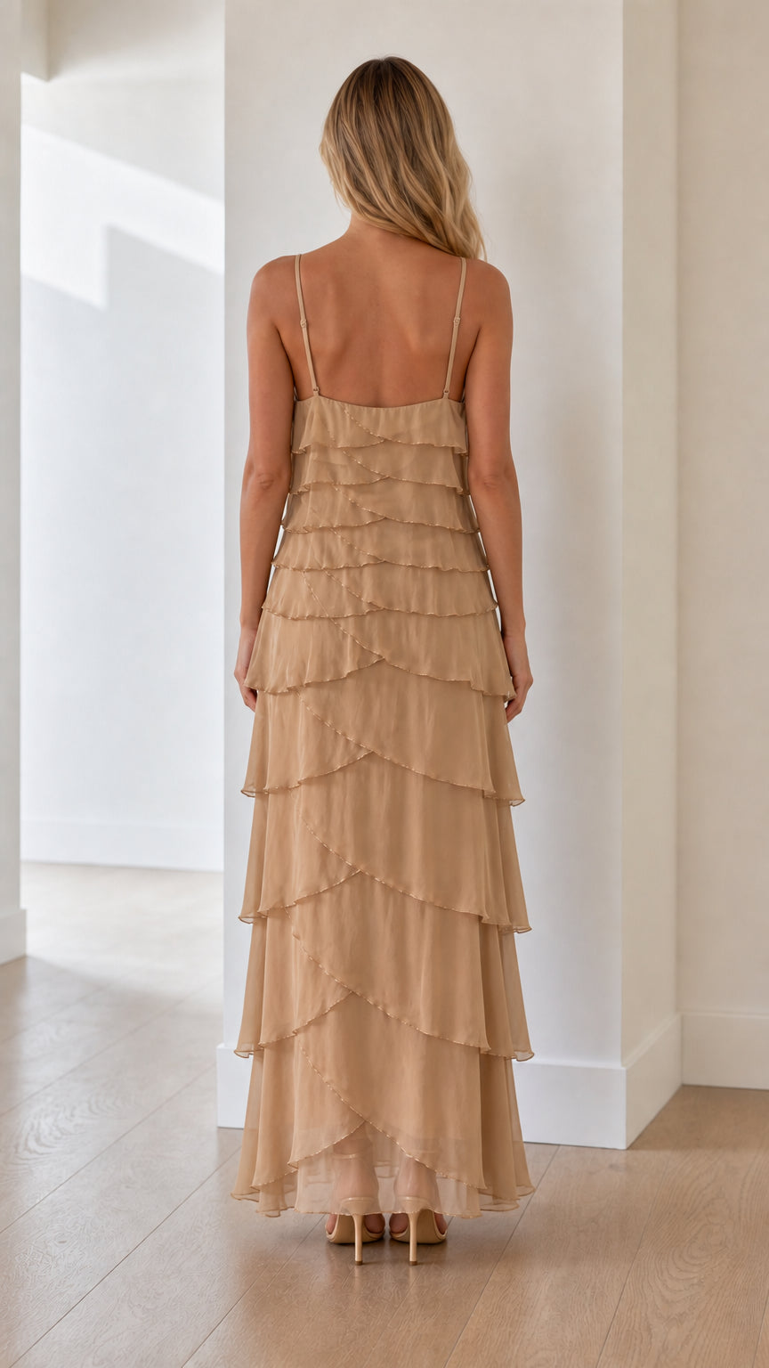 Model wearing beige tiered ruffle maxi dress from the back