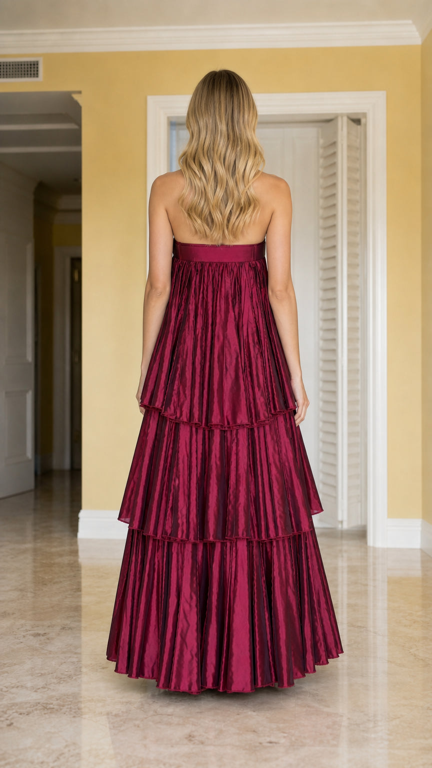 Back view of burgundy strapless maxi dress showing tiered ruffled layers