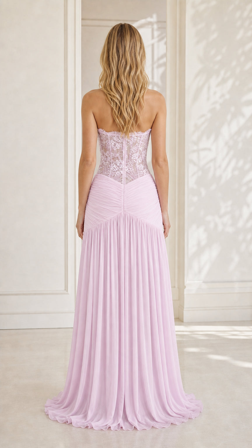 Model wearing lavender strapless lace evening dress, back view