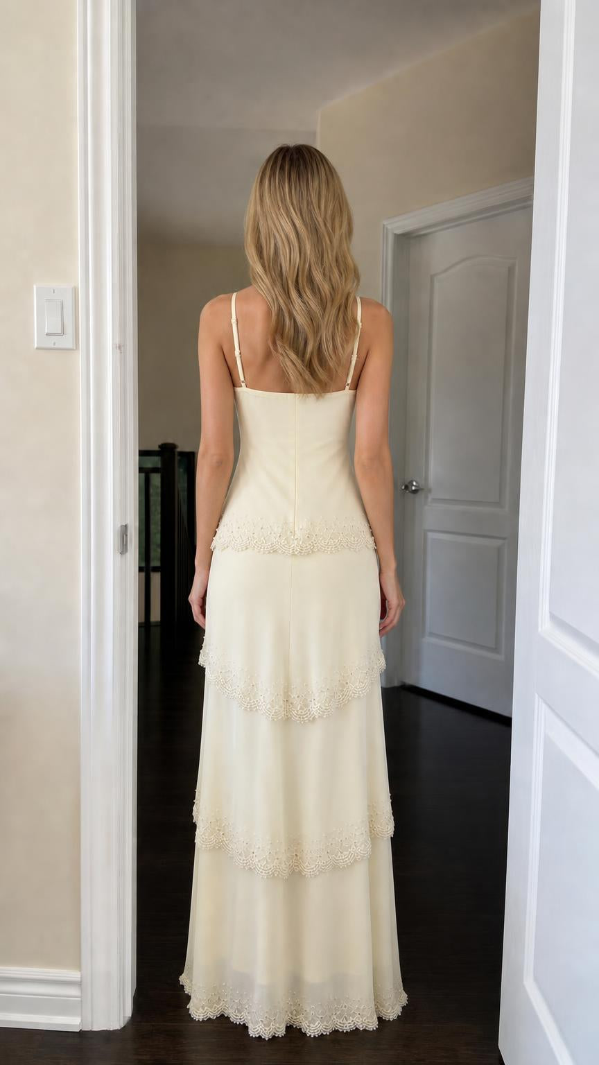 Back view of woman wearing yellow tiered lace maxi dress