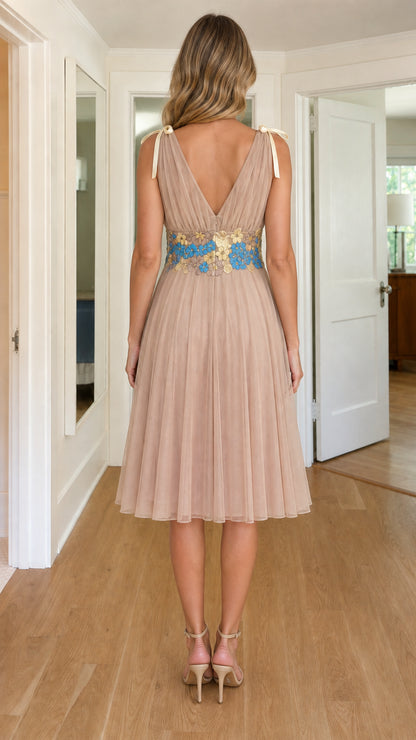 Back view of woman wearing champagne V-back pleated party dress