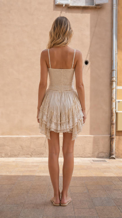 Back view showcasing ruffled hem of the cream shorts
