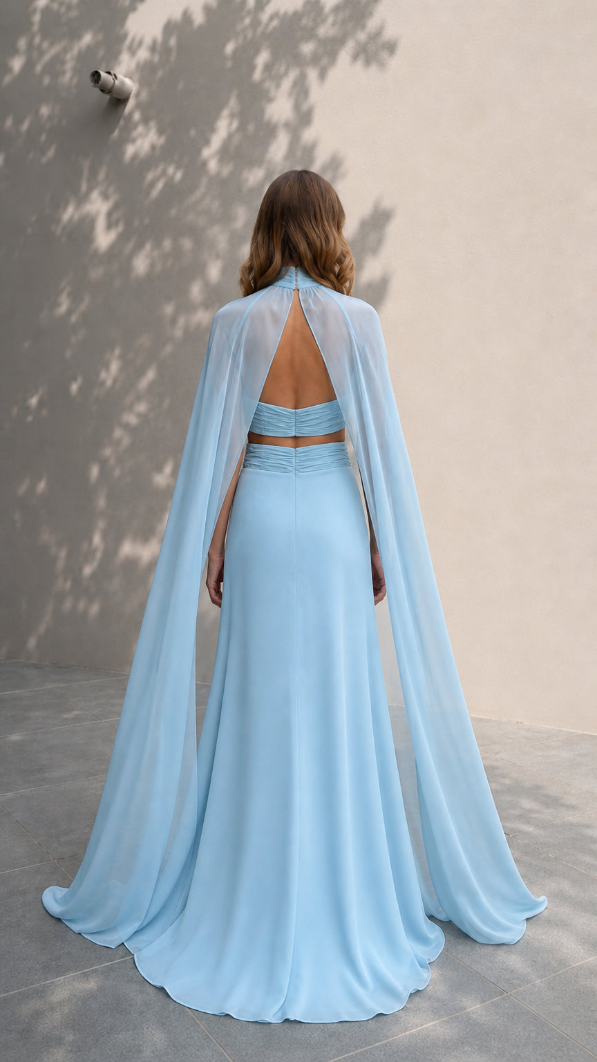 Back view showcasing sheer flowing cape on light blue evening dress