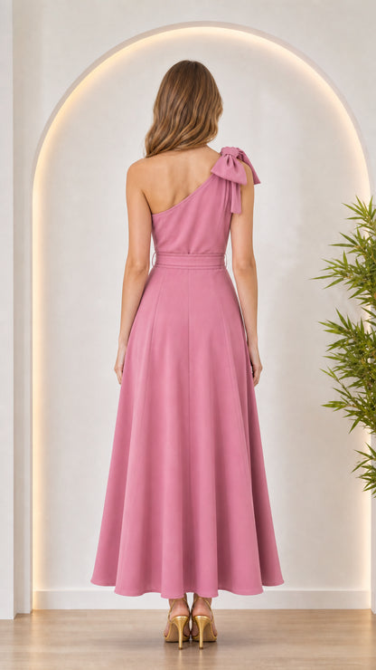 Back view of woman in pink bow shoulder maxi dress