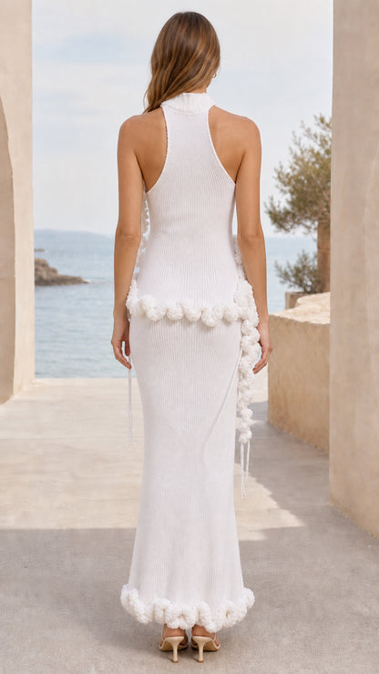 Back view of woman wearing white high-neck ribbed knit maxi dress